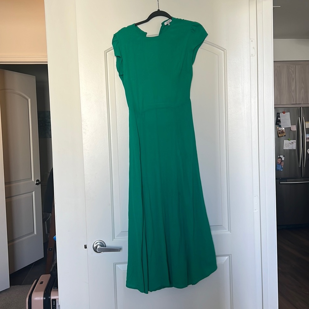 Gorgeous long green dress with slit up tight thigh and half open back.